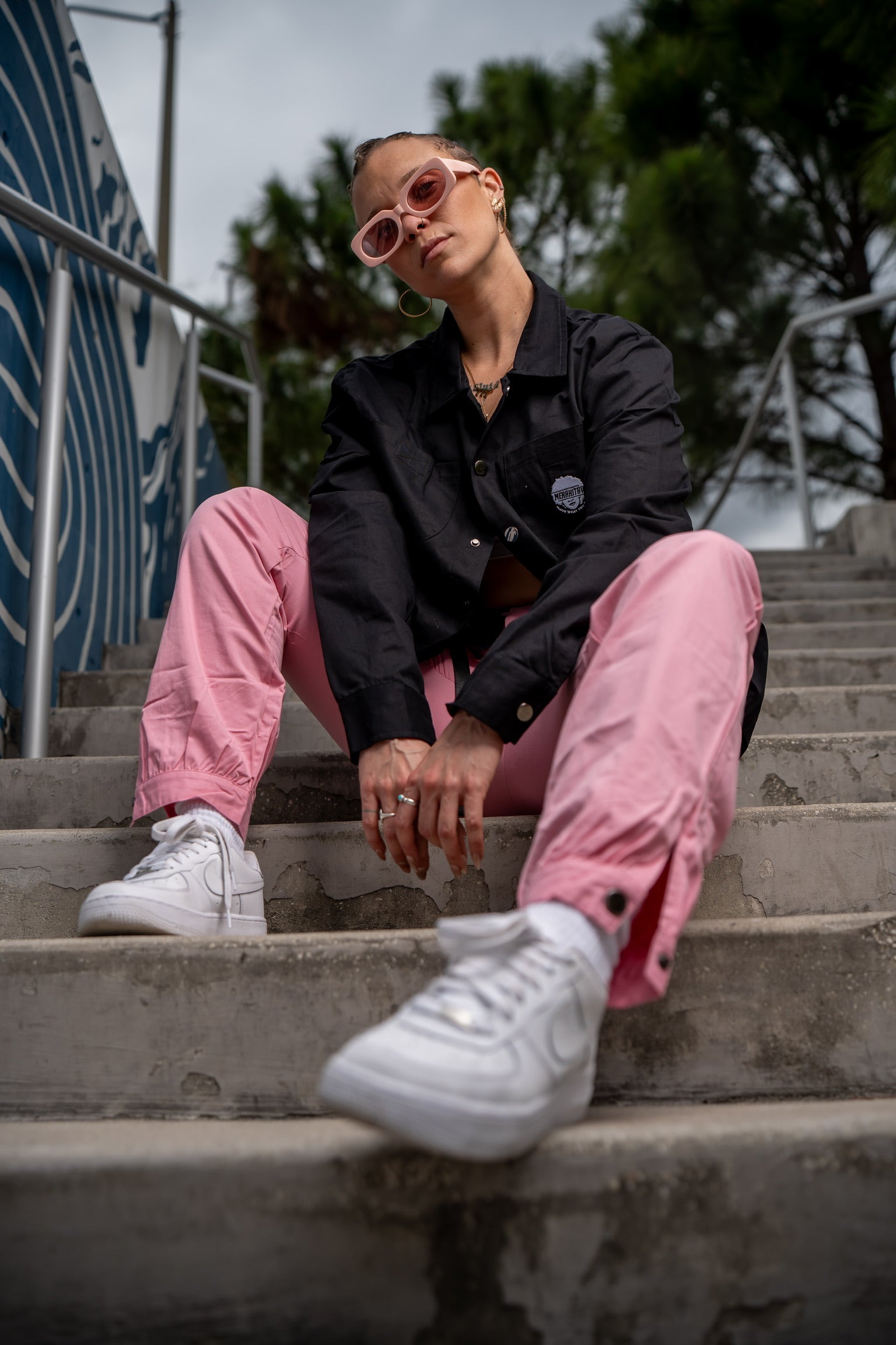 Woman wearing the merakitay cargo jacket. Black cargo/ trucker jacket with 4 pockets and buttons for cuffs. Buttons are in the middle of the jacket to button up if need be. There is a collar as well to be dressed up or dressed down.